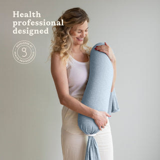 Woman holding a blue bbhugme nusing pillow with 